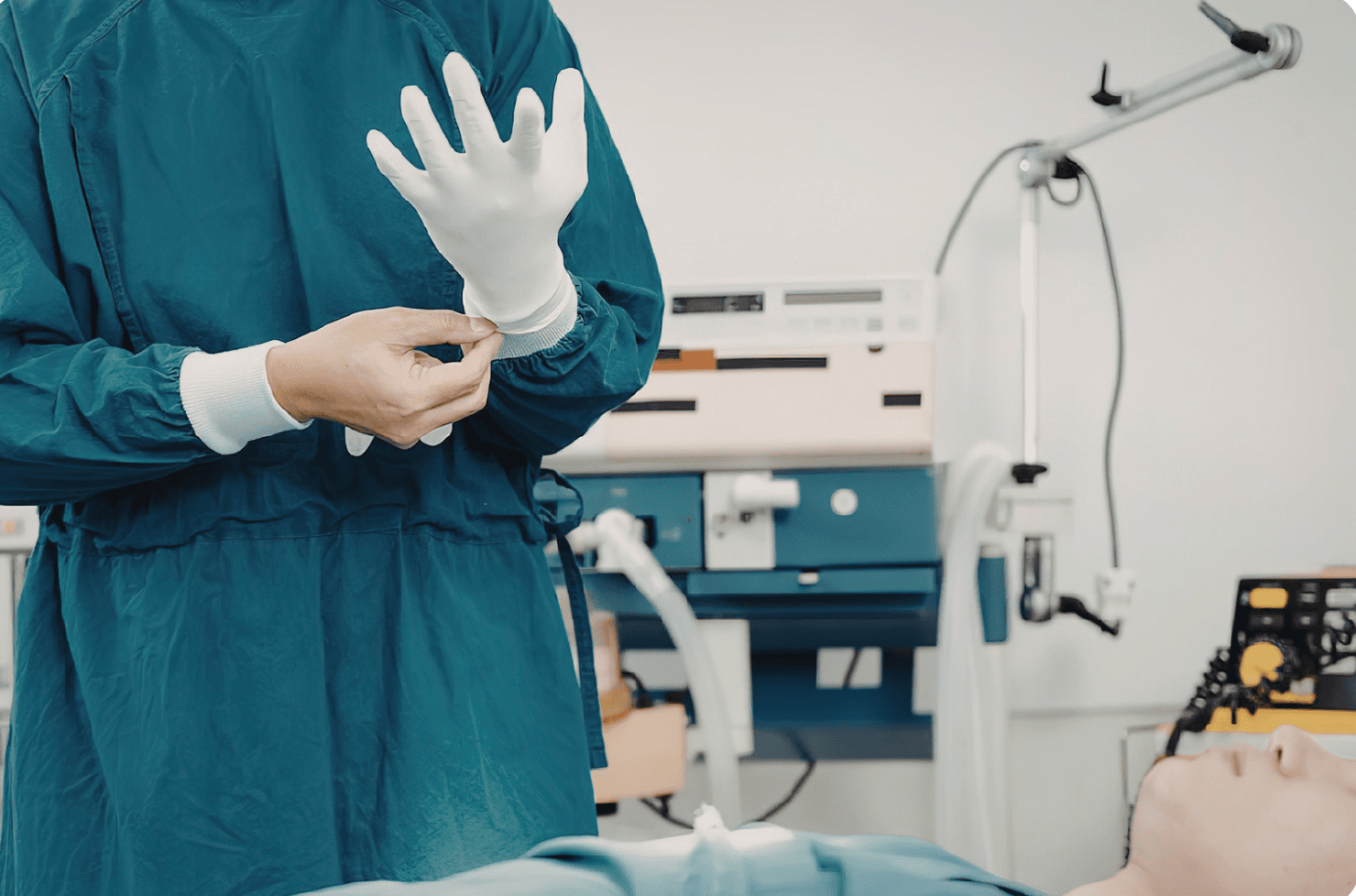 Surgeon putting on gloves